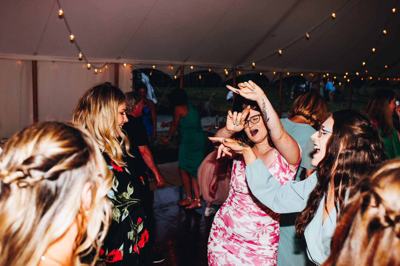 Wedding guests party with their arms in the air