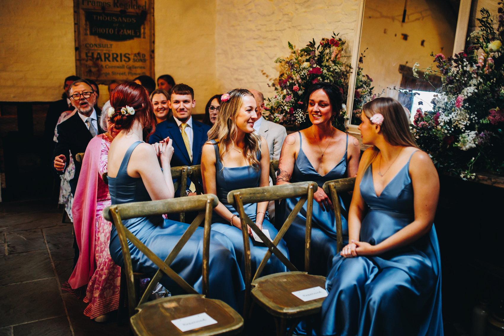 Bridesmaids sat waiting for the ceremony in periwinkle blue satin dresses