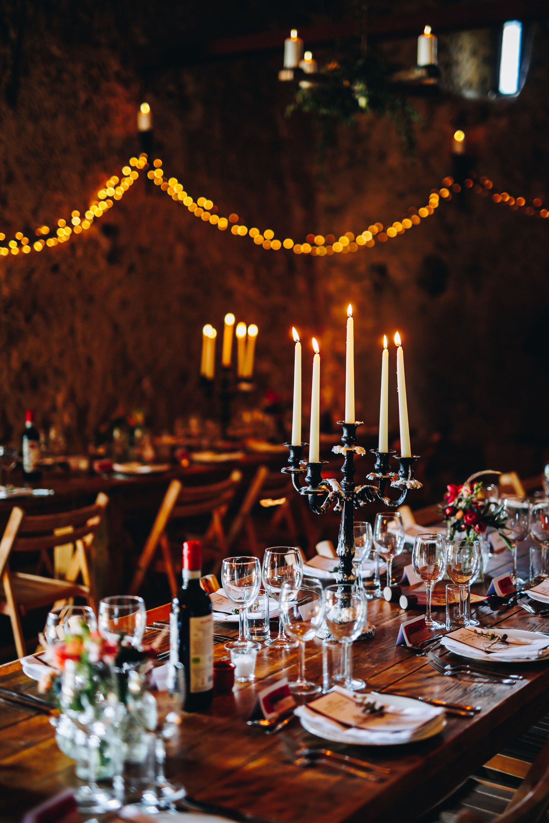 Candelabra and table decor in a darkened barn setting