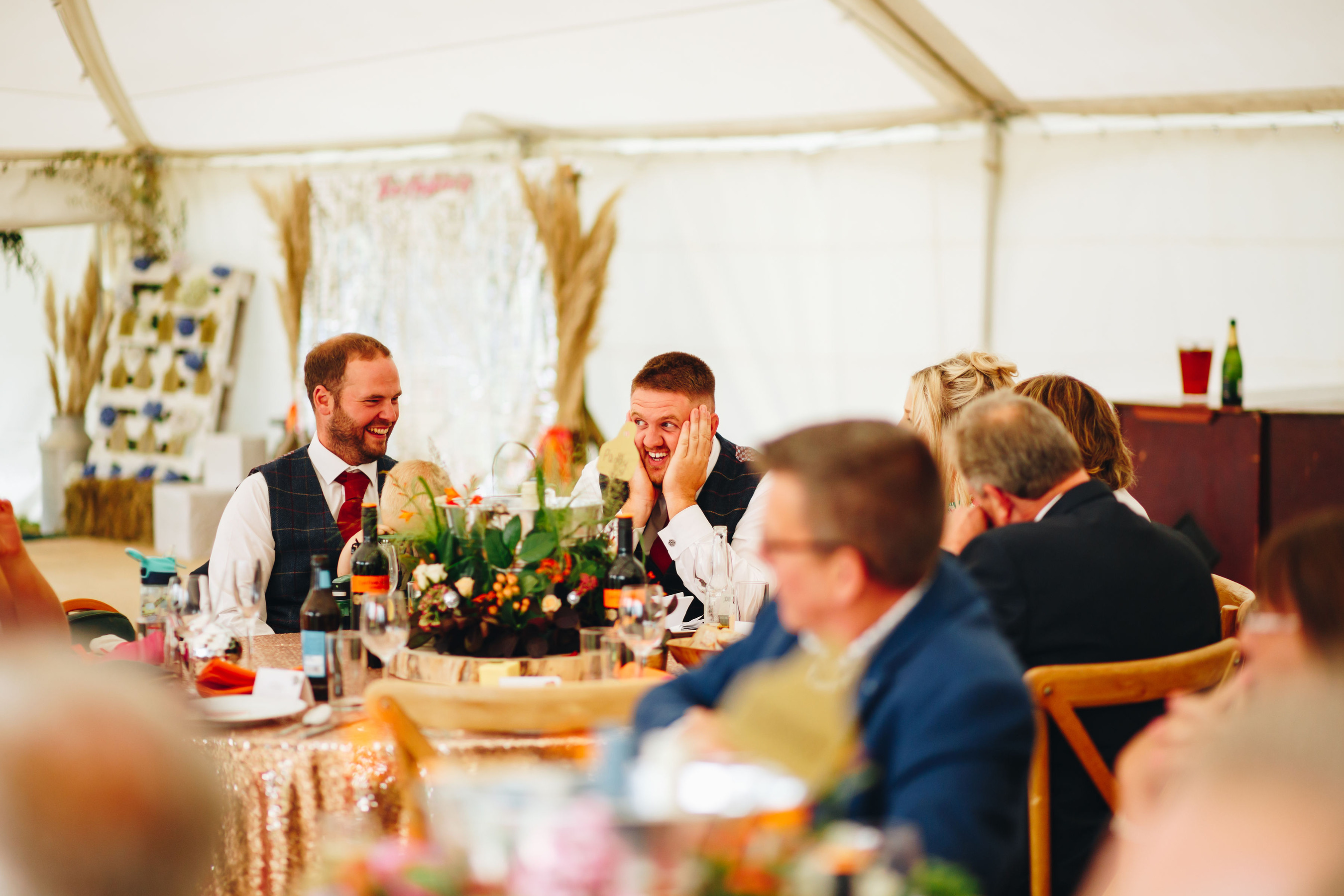 Groomsman holds face in dread during speeches as groom laughs at him