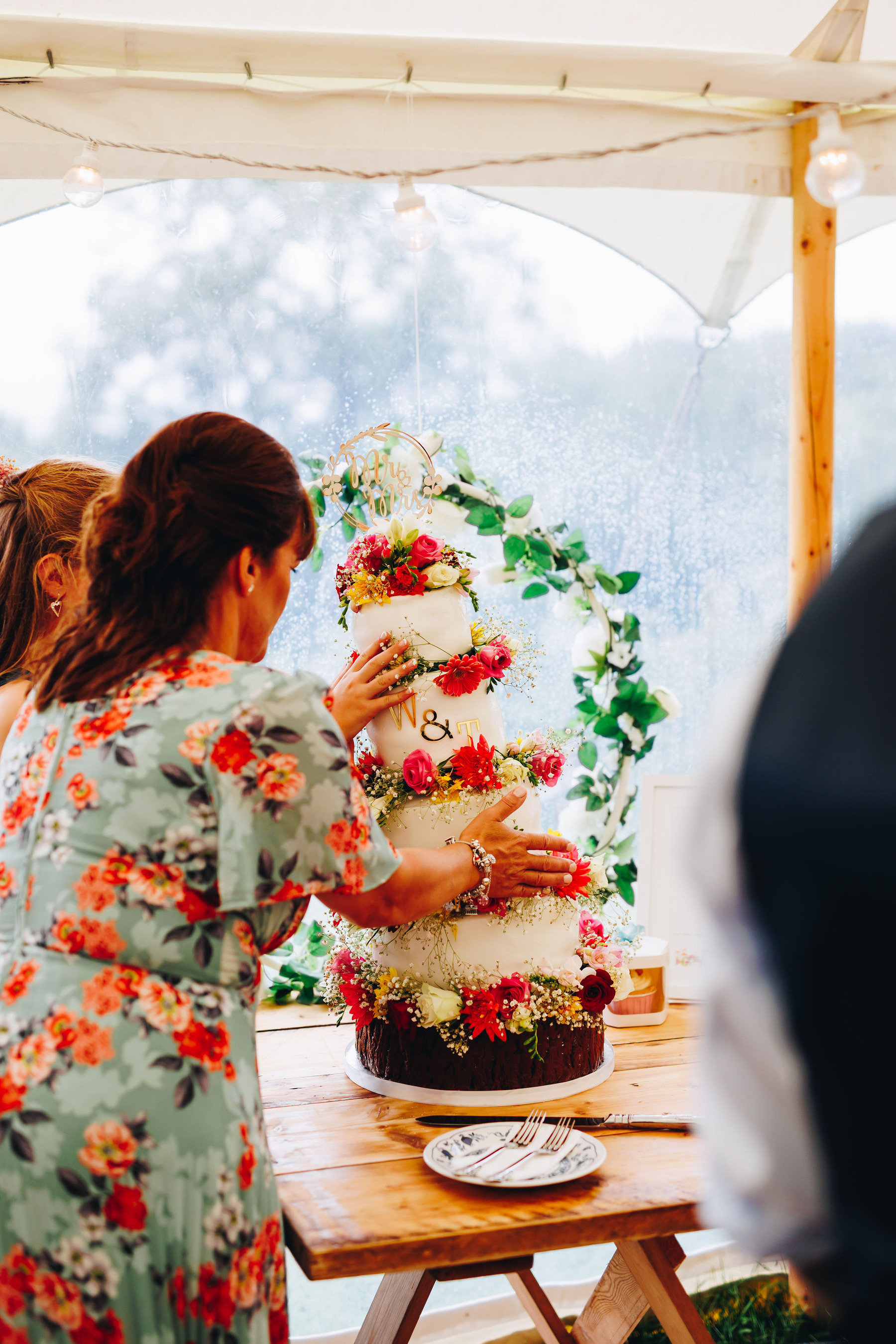 4 tier cake falls - two guests try to stop its' slip