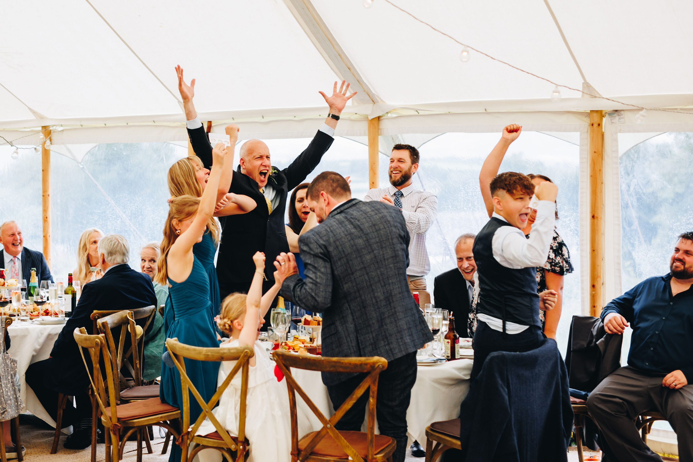Guests cheer at wedding reception