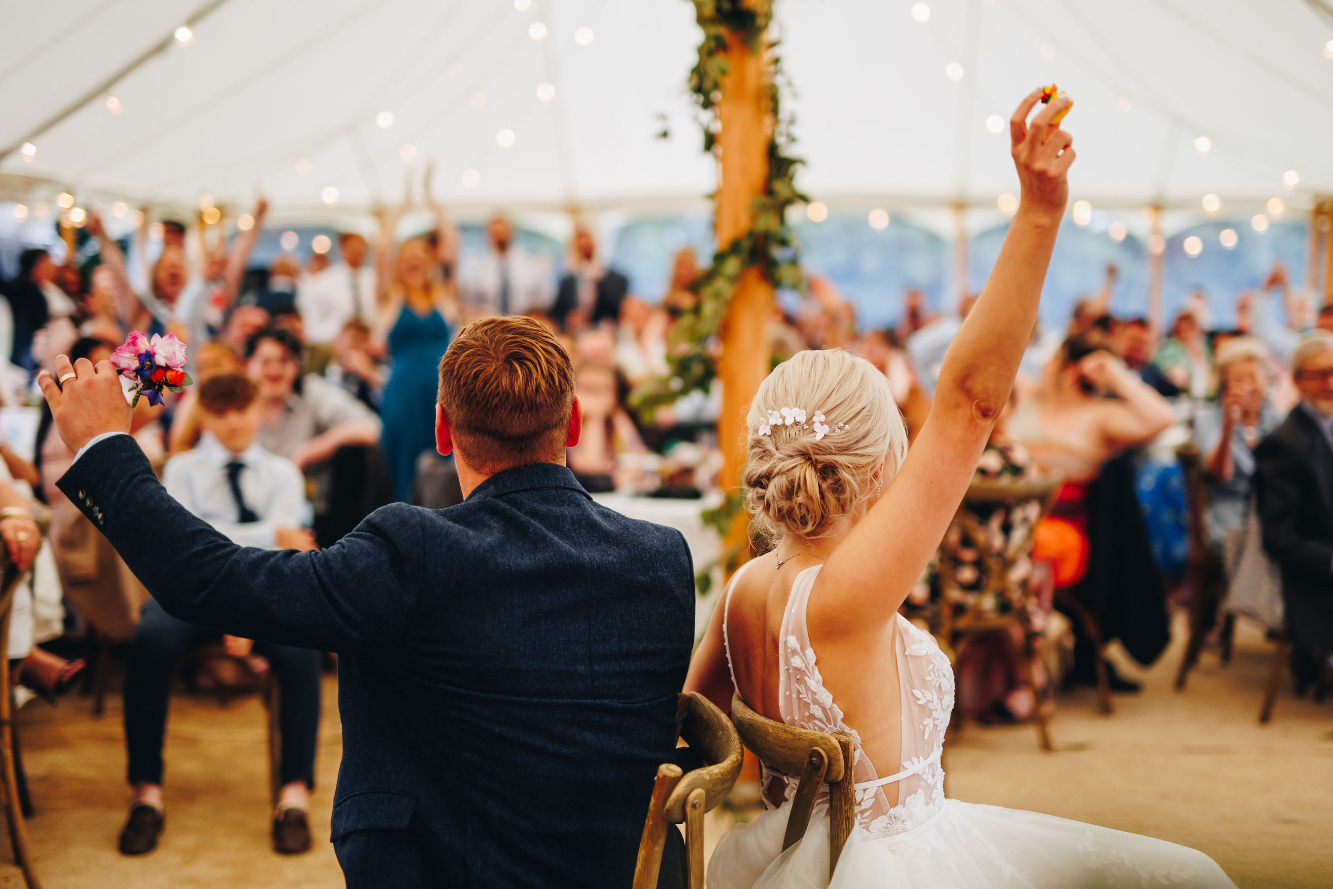 Bride and groom play 'his or hers', in front of their wedding guests
