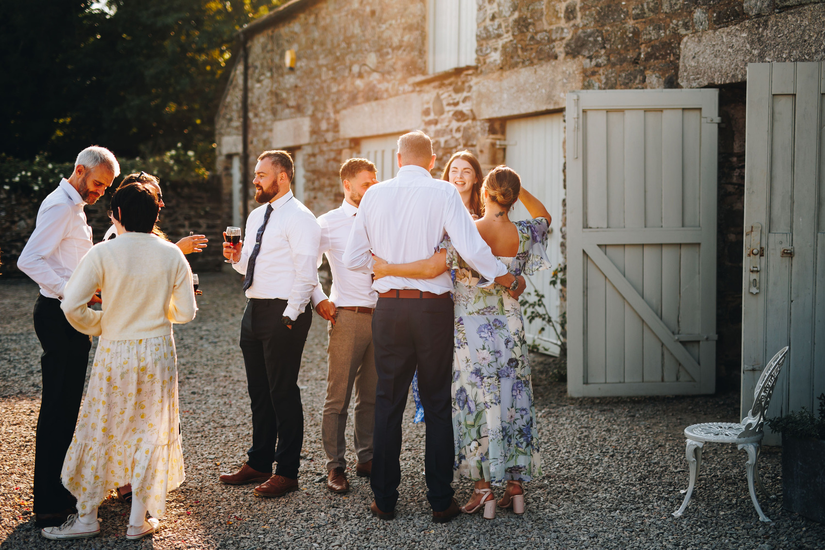 Evening sunshine and guests mingling in courtyard
