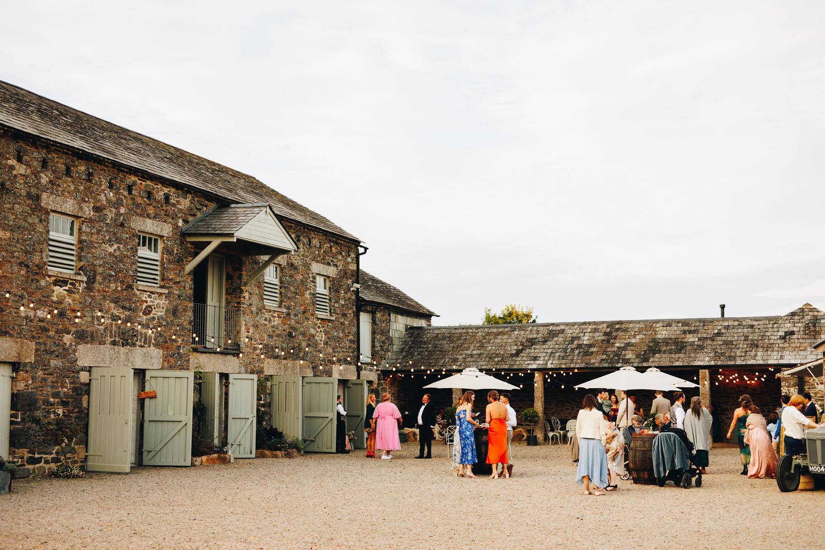 Wedding guests in courtyard of barn