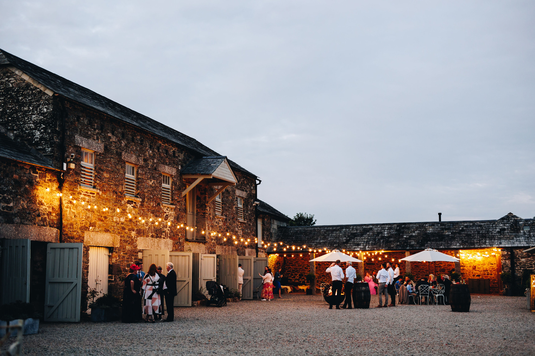 Wedding evening guests mingling in courtyard