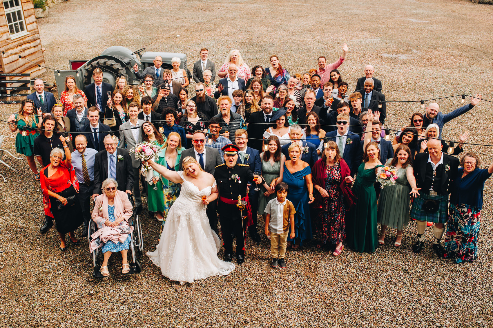 Wedding group photo with cheering guests