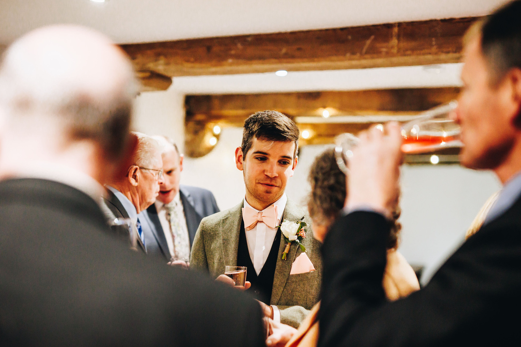 Groom chatting with guests at wedding reception