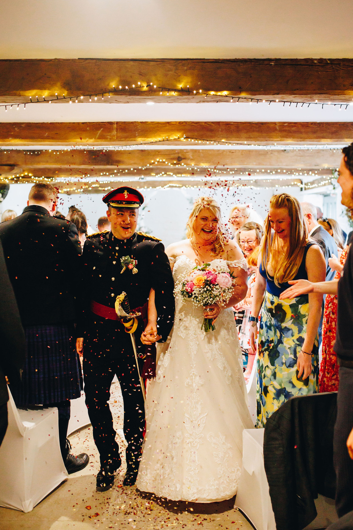 Couple walk up the aisle in confetti