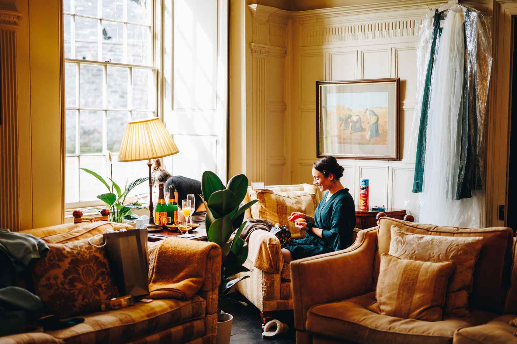 Bridesmaid sat in chair in a robe on wedding morning