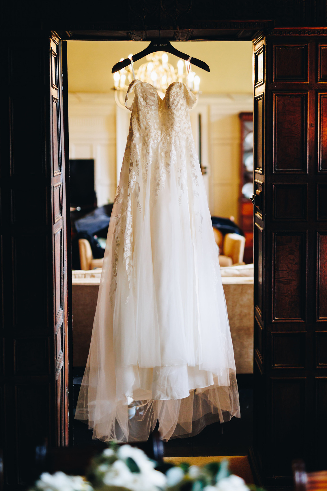 Bridal gown hung in doorway