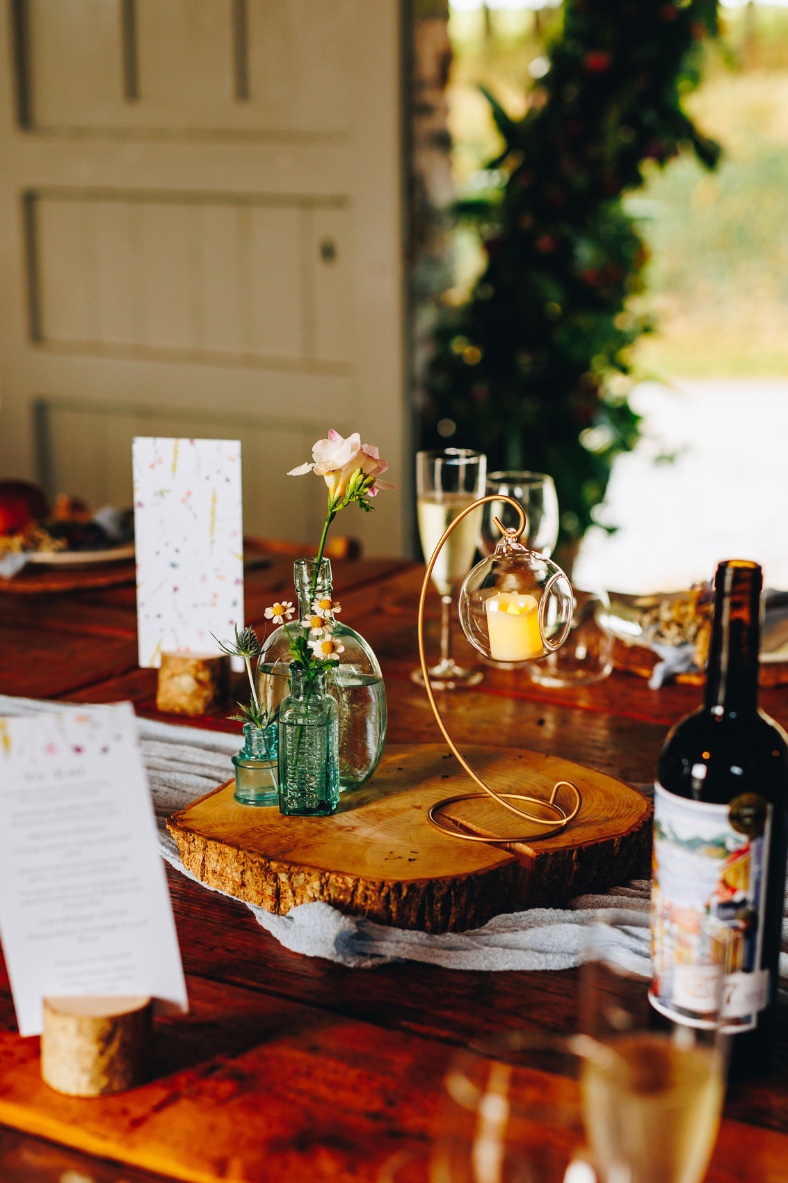 Close up of candles and flowers on table