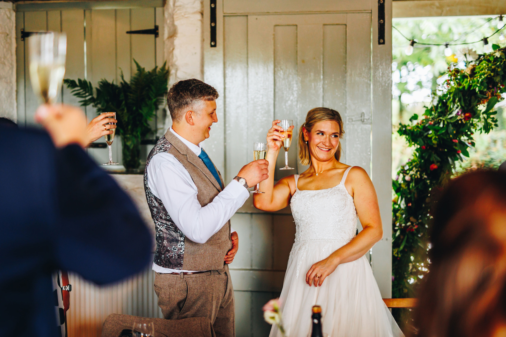 Newly married couple cheersing at wedding reception