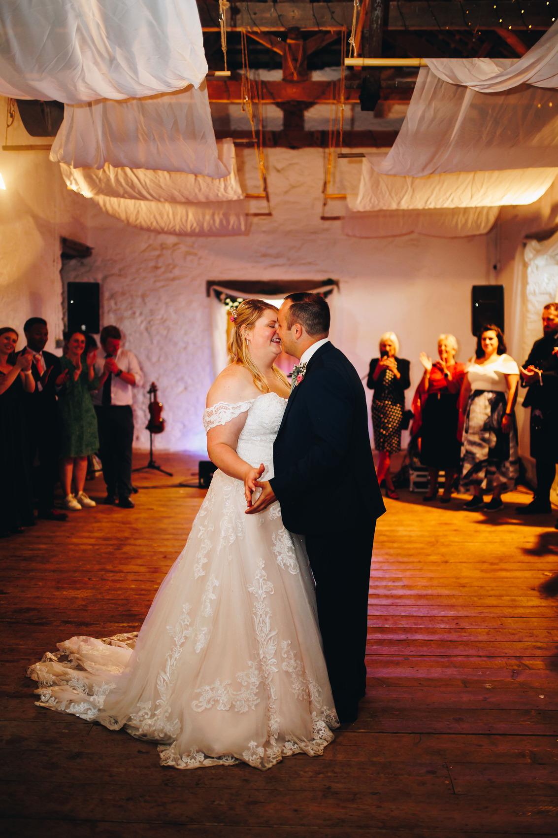 Newly weds having their first dance in a barn