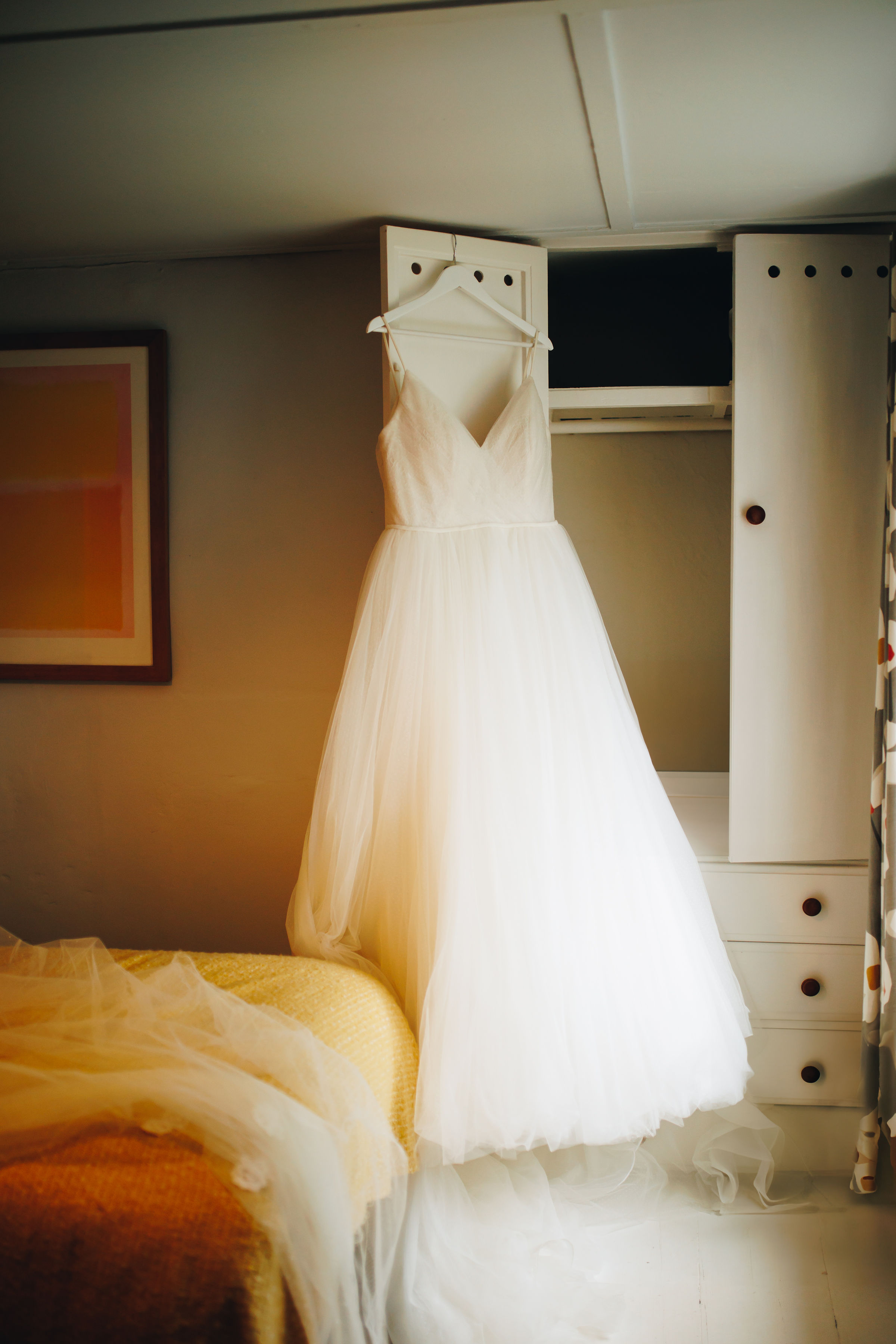 Wedding dress hanging on cupboard door