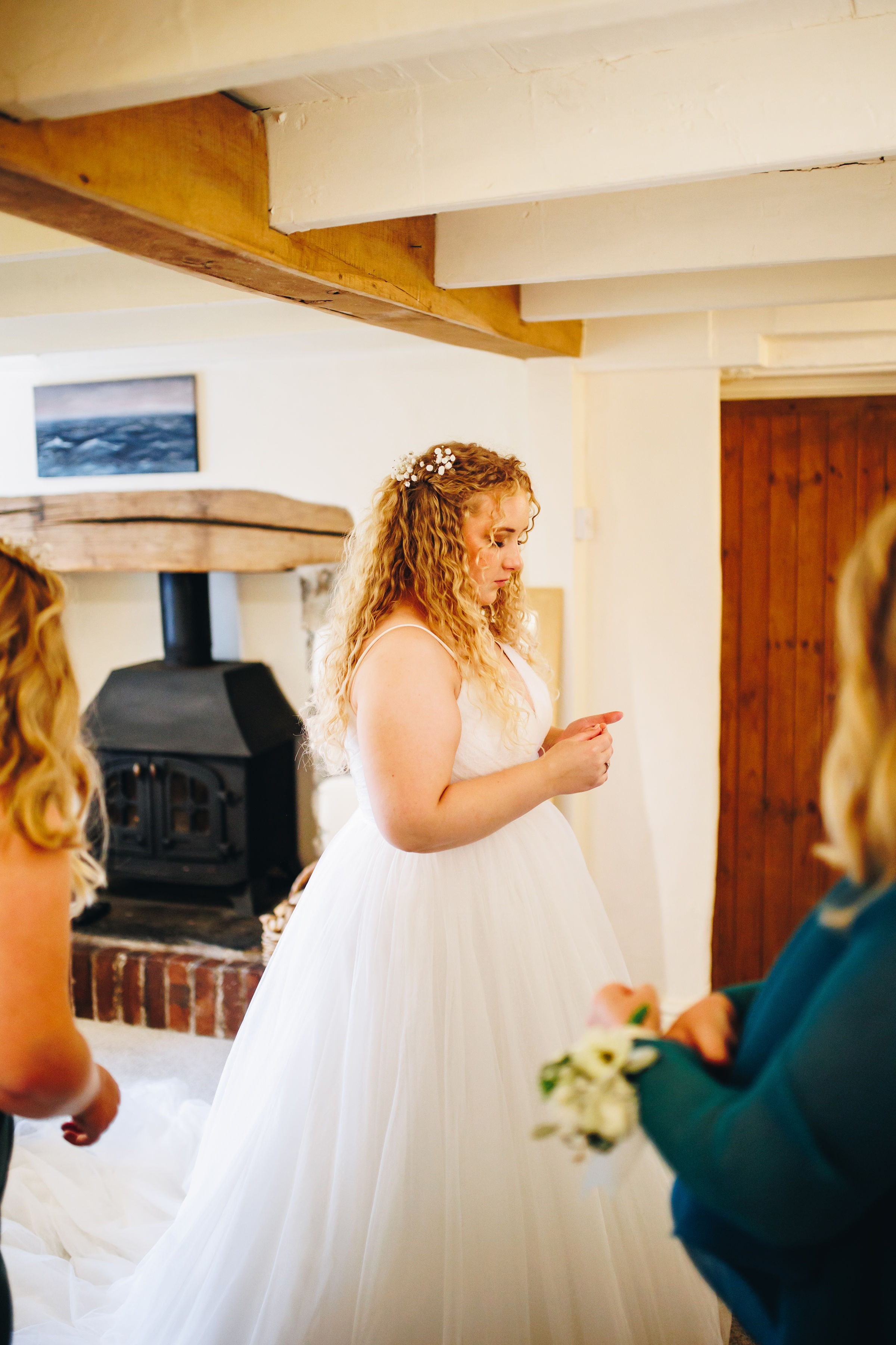 Bride stood in her lounge with her mum and sister