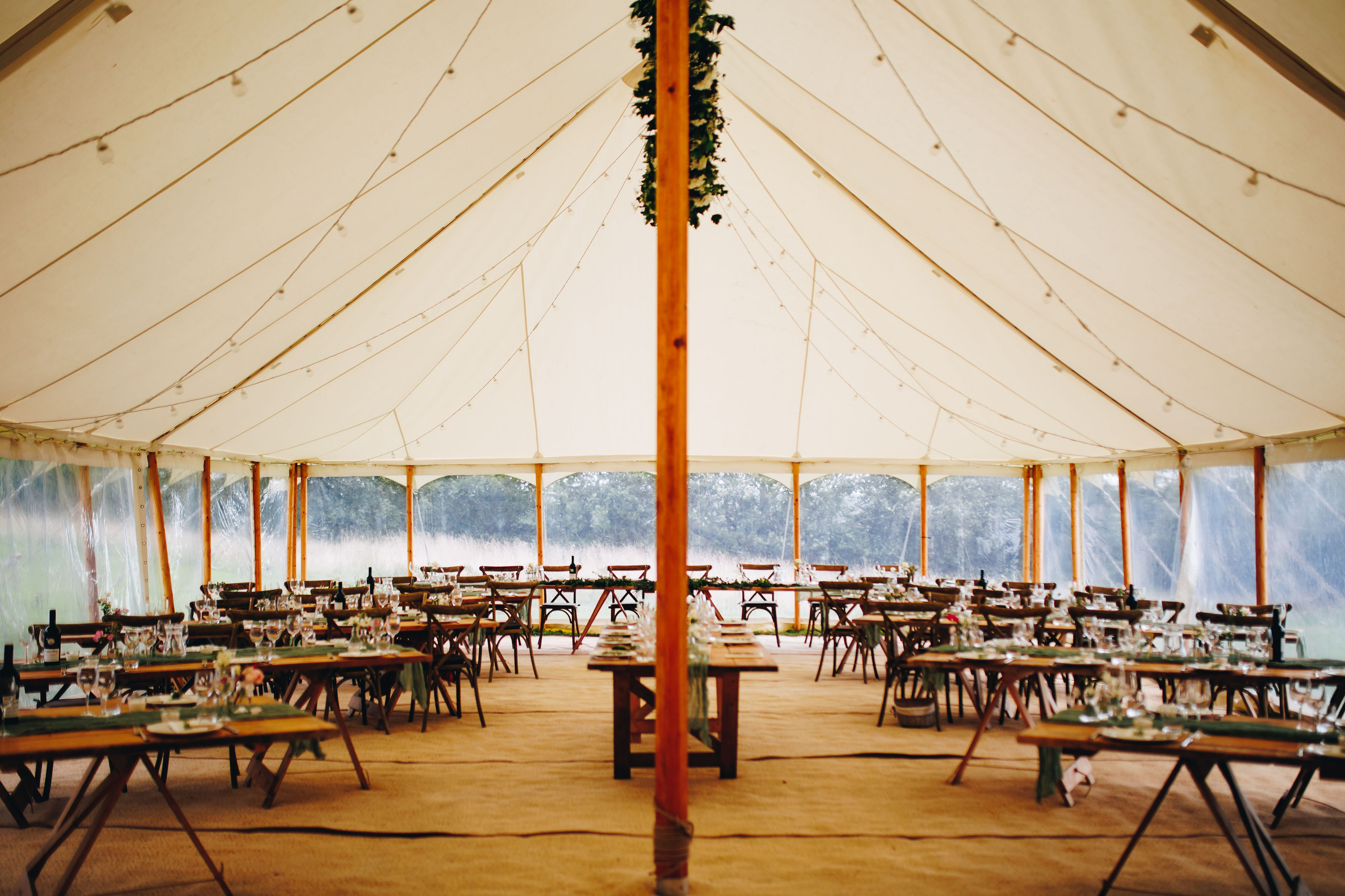 Photo of a large marquee with long banquet tables
