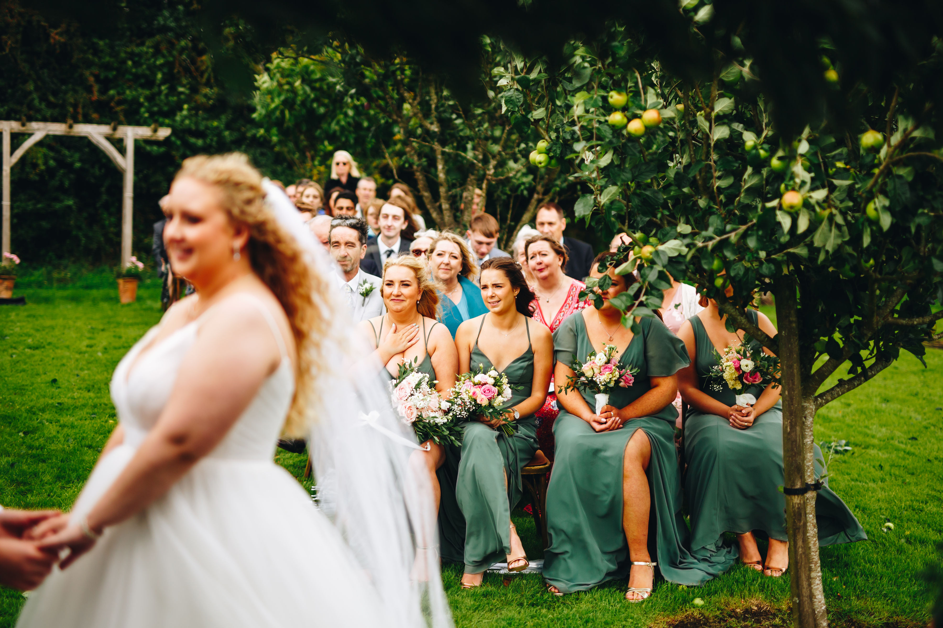 Bridesmaids watch bride in the foreground get married
