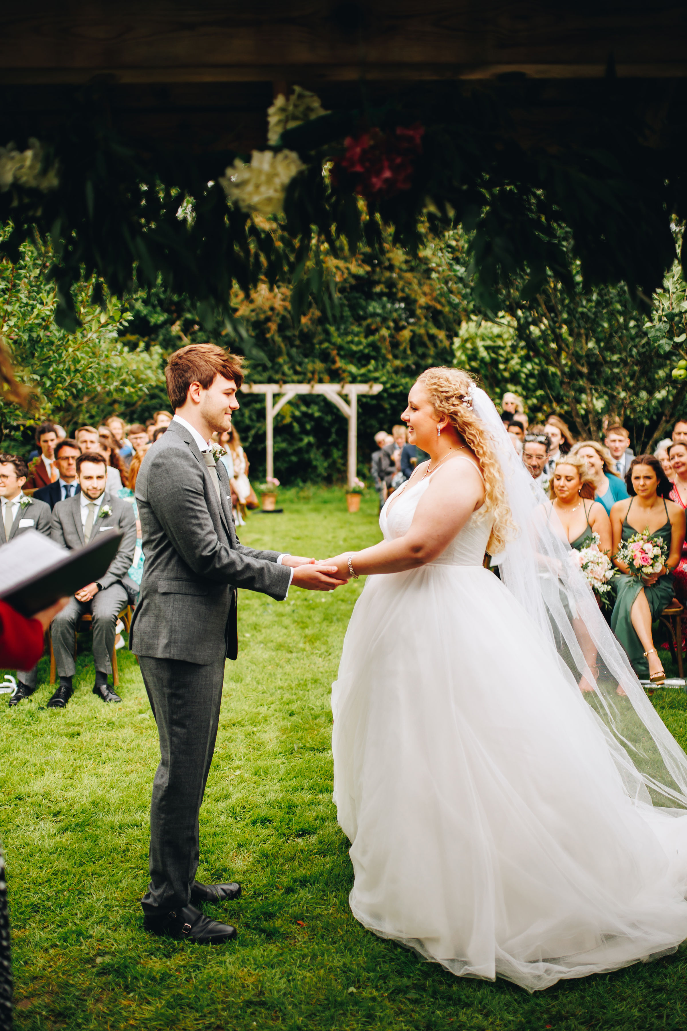 Bride and groom stood holding hands during their wedding ceremony