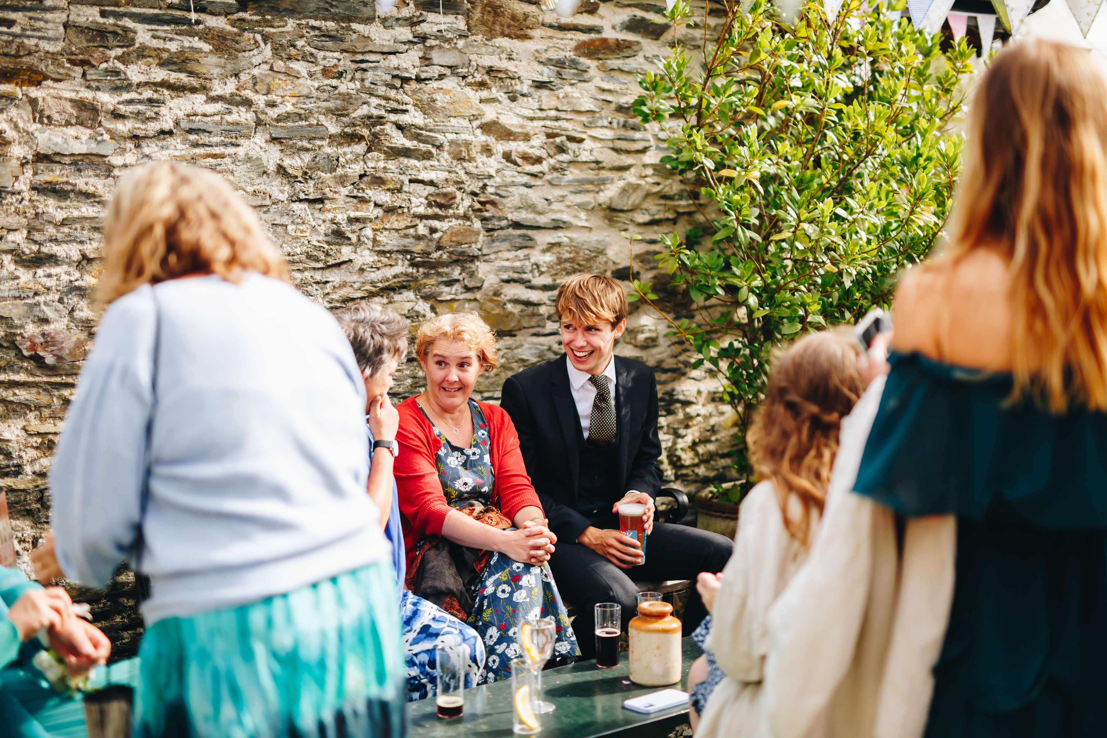 Courtyard wedding reception with guests sat around chatting