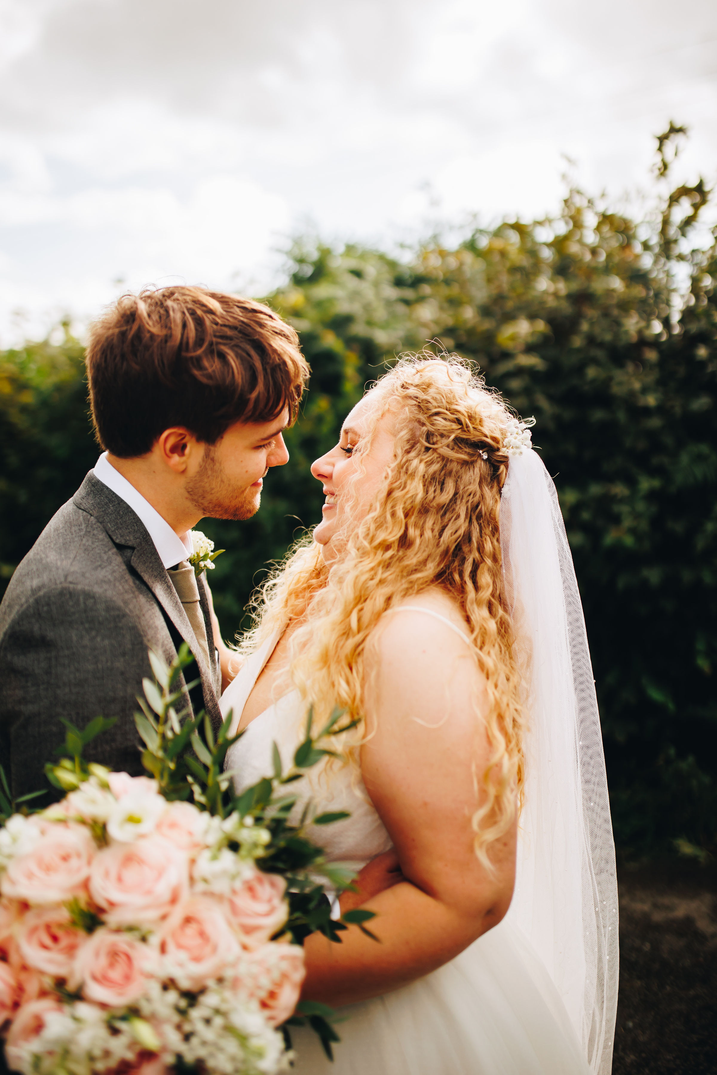 Couple photos at sunset - bride and groom smiling