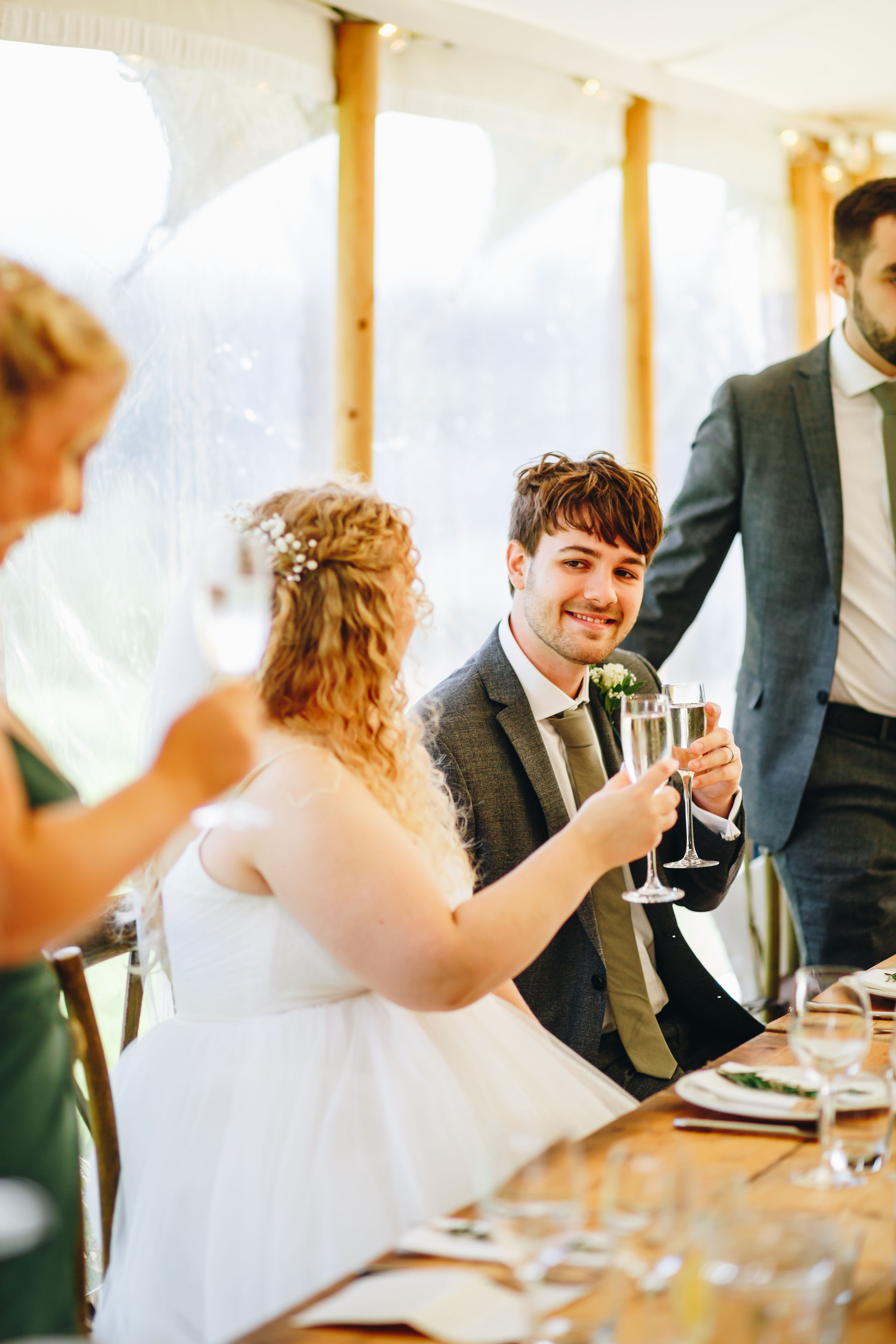 Bride and groom clink glasses at speeches