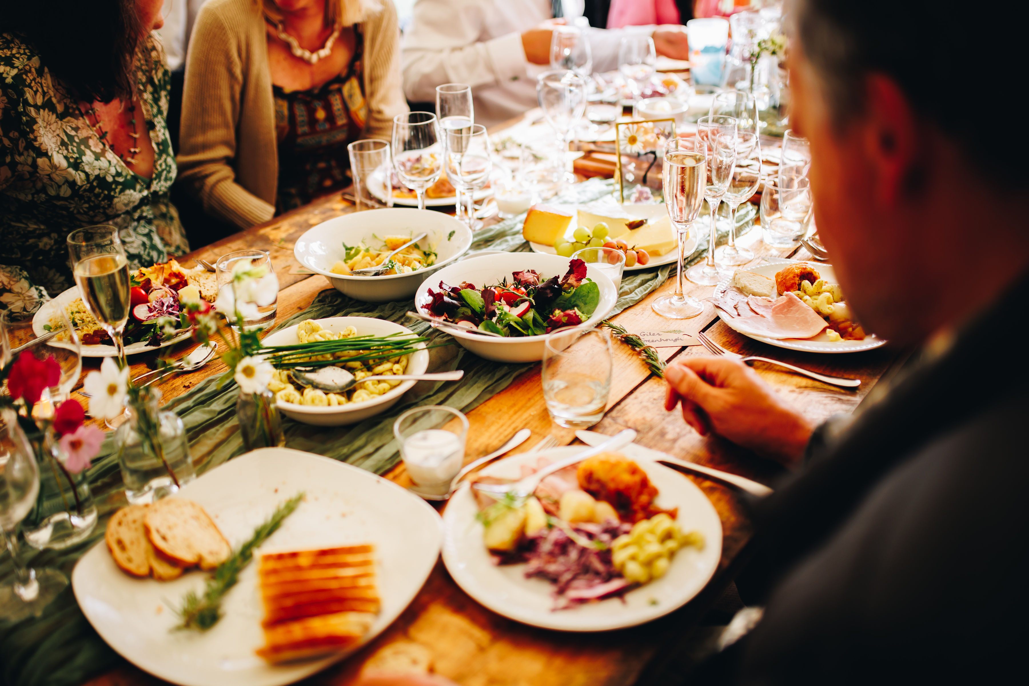 Sharing platters of food on a wooden table