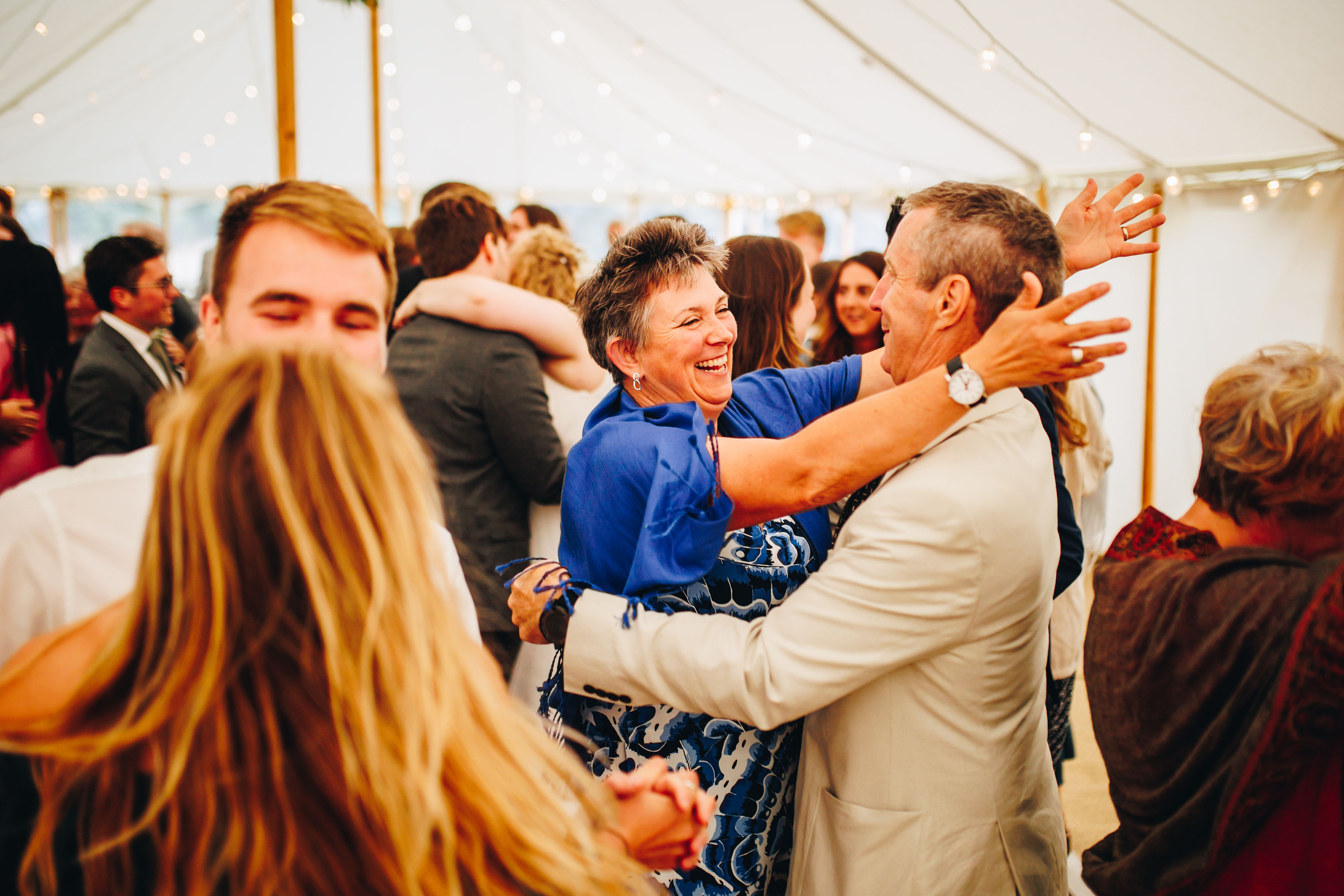Guests dancing on the dancefloor and smiling