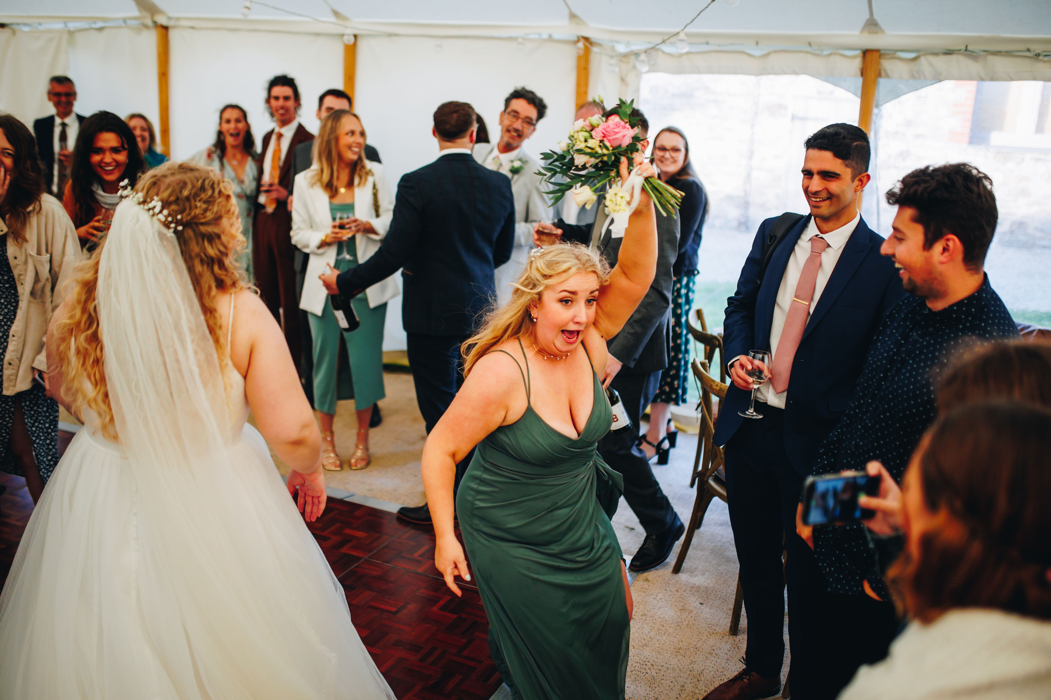 Bouquet toss - cousin caught it and sister then stole it