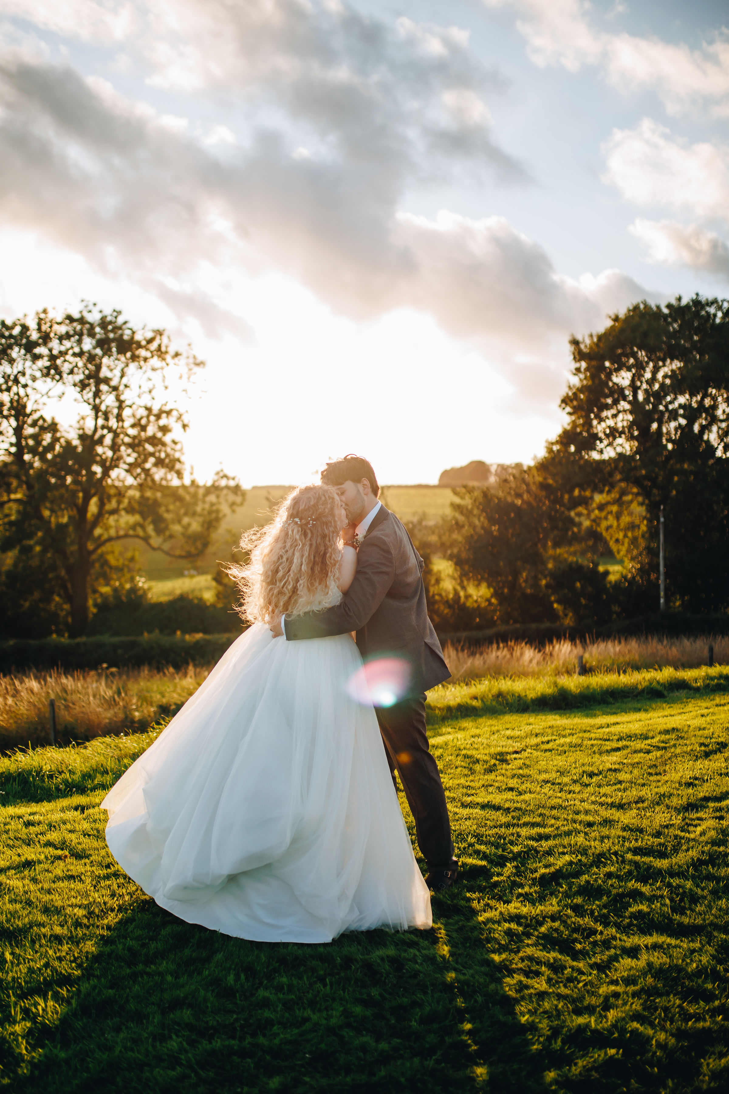 Couple dancing at sunset in a field