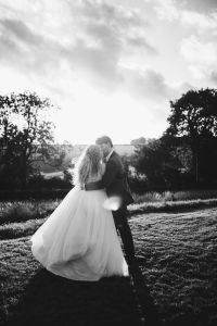 Couple dancing at sunset in a field
