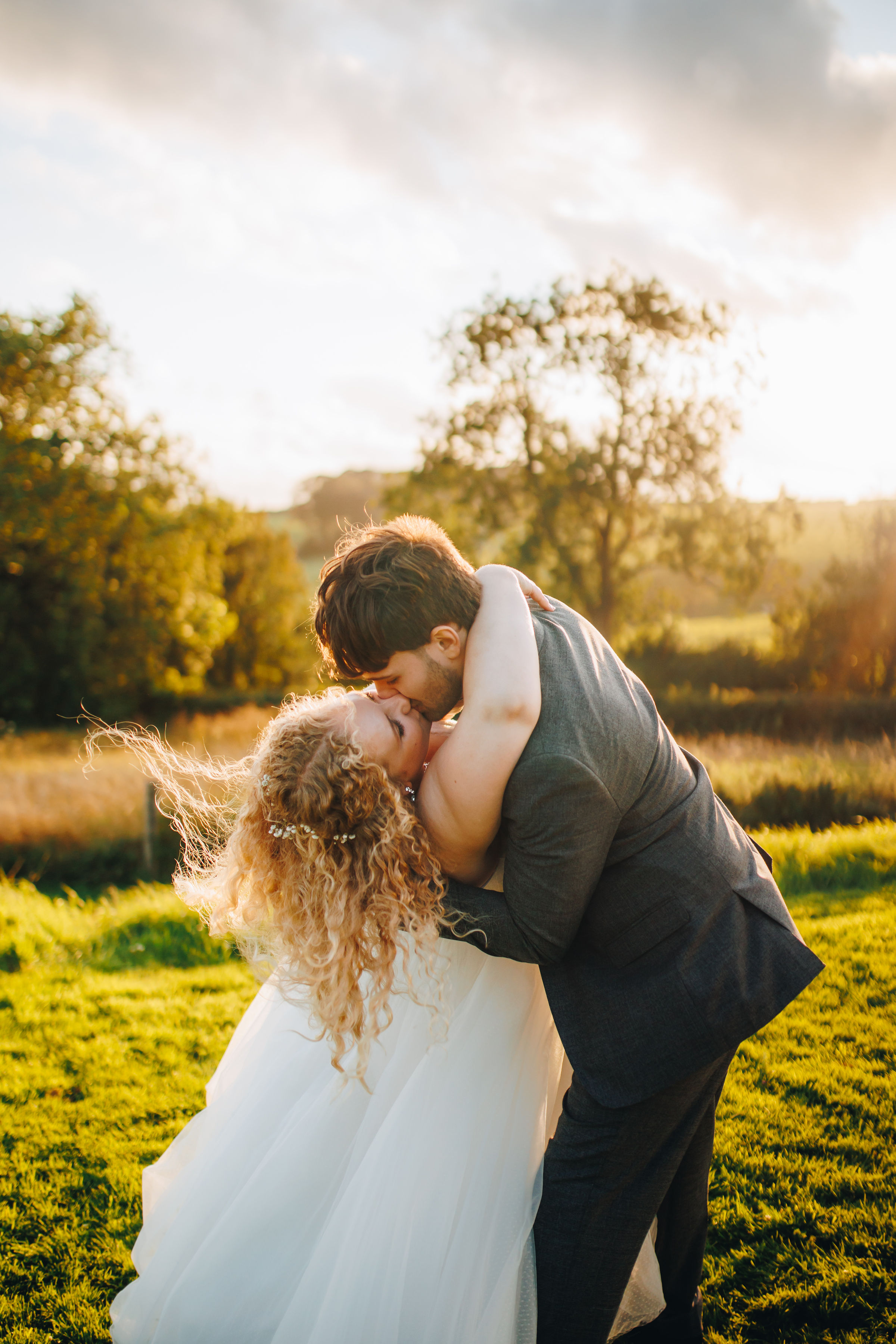 Couple dancing at sunset in a field