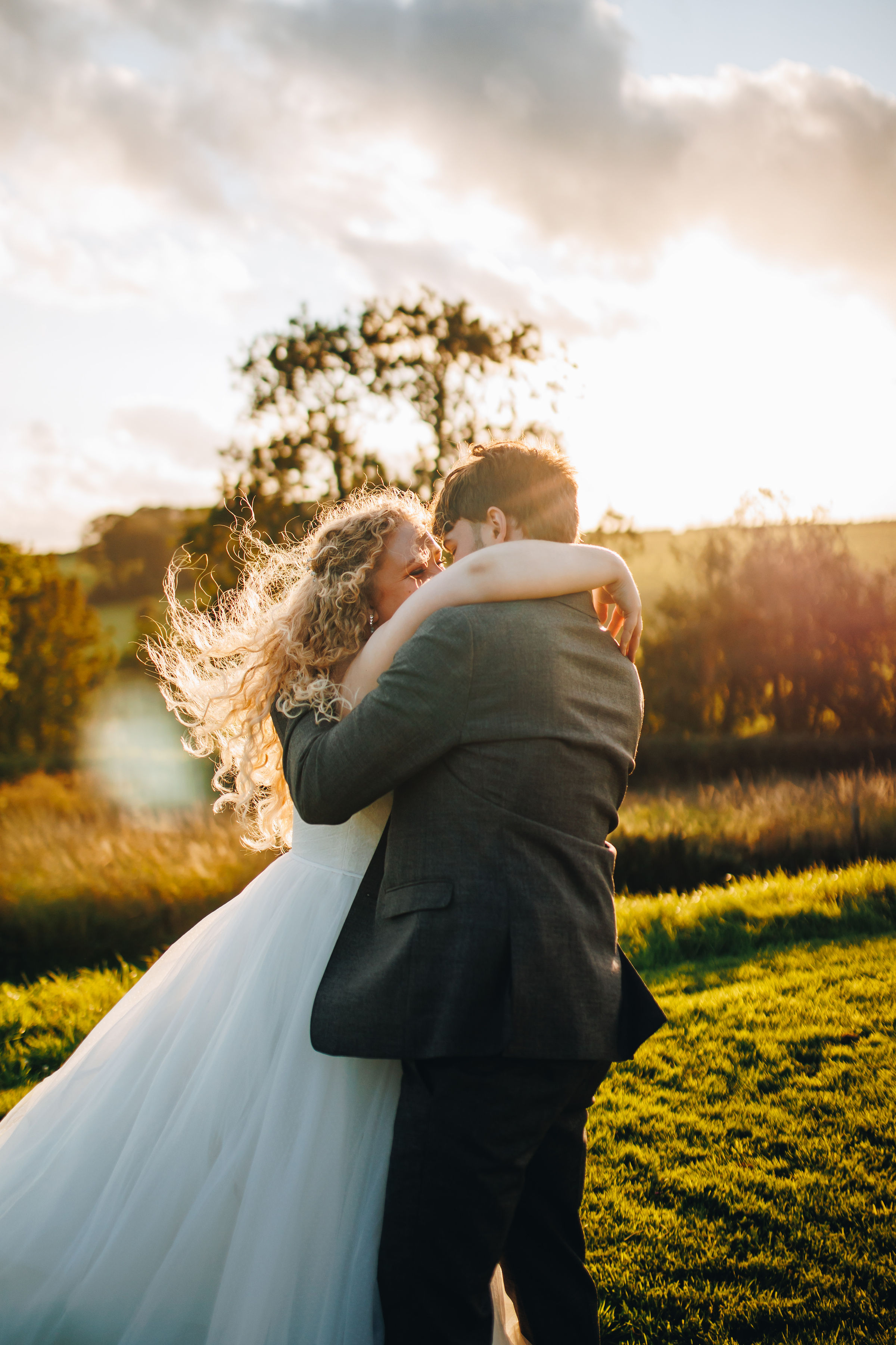 Couple dancing at sunset in a field