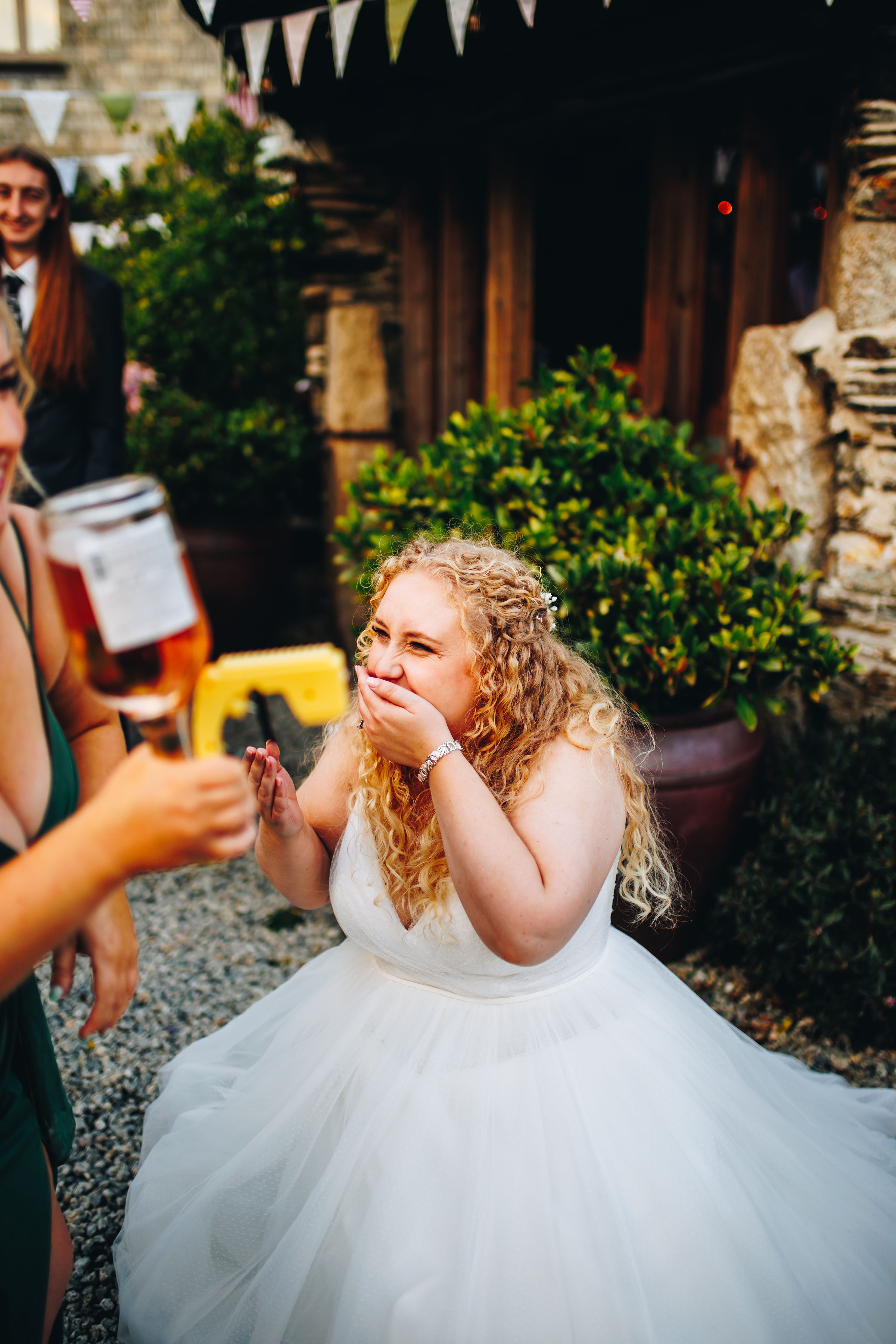 Bridesmaid using Prosecco gun