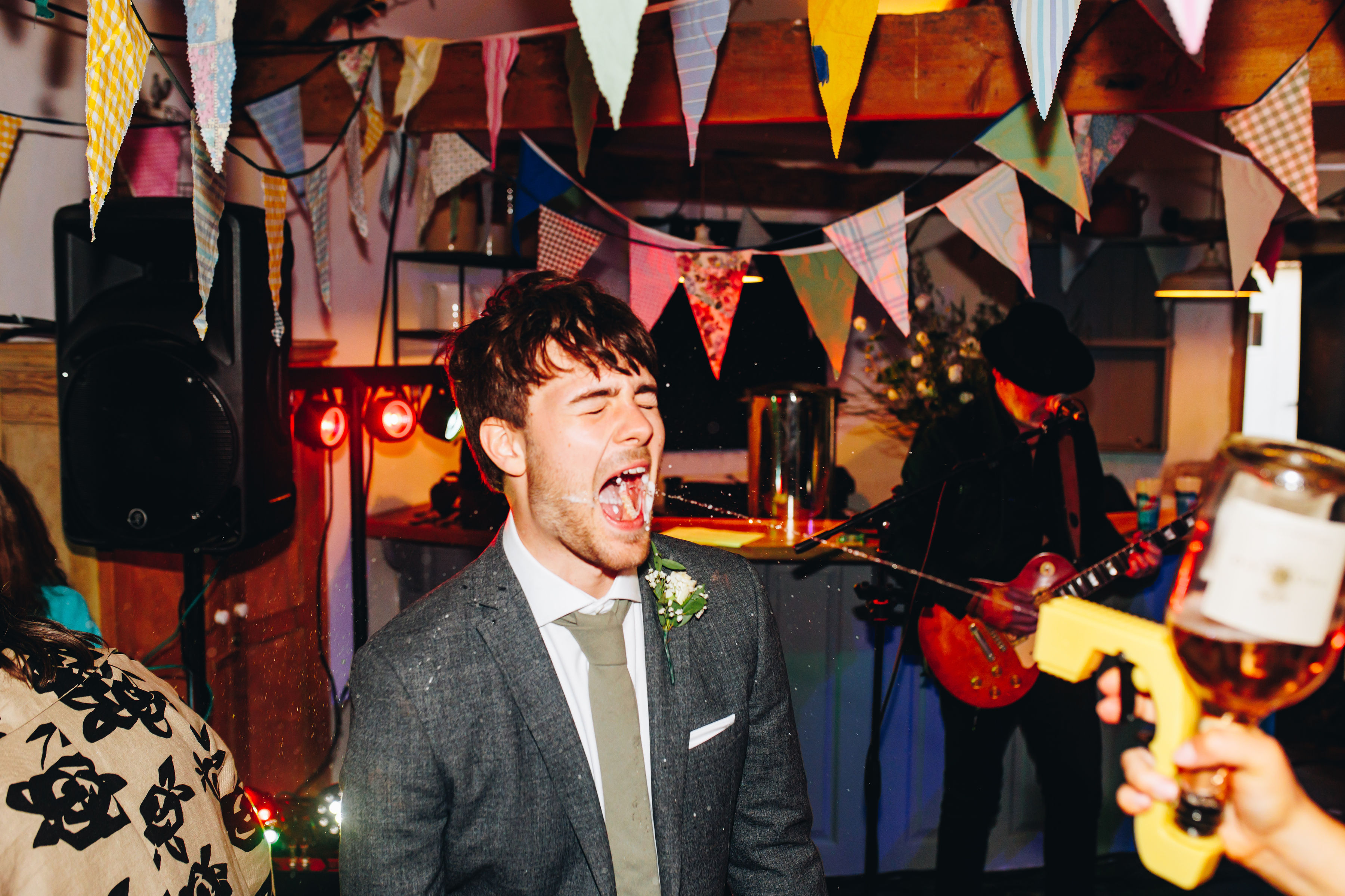 Bridesmaid using Prosecco gun