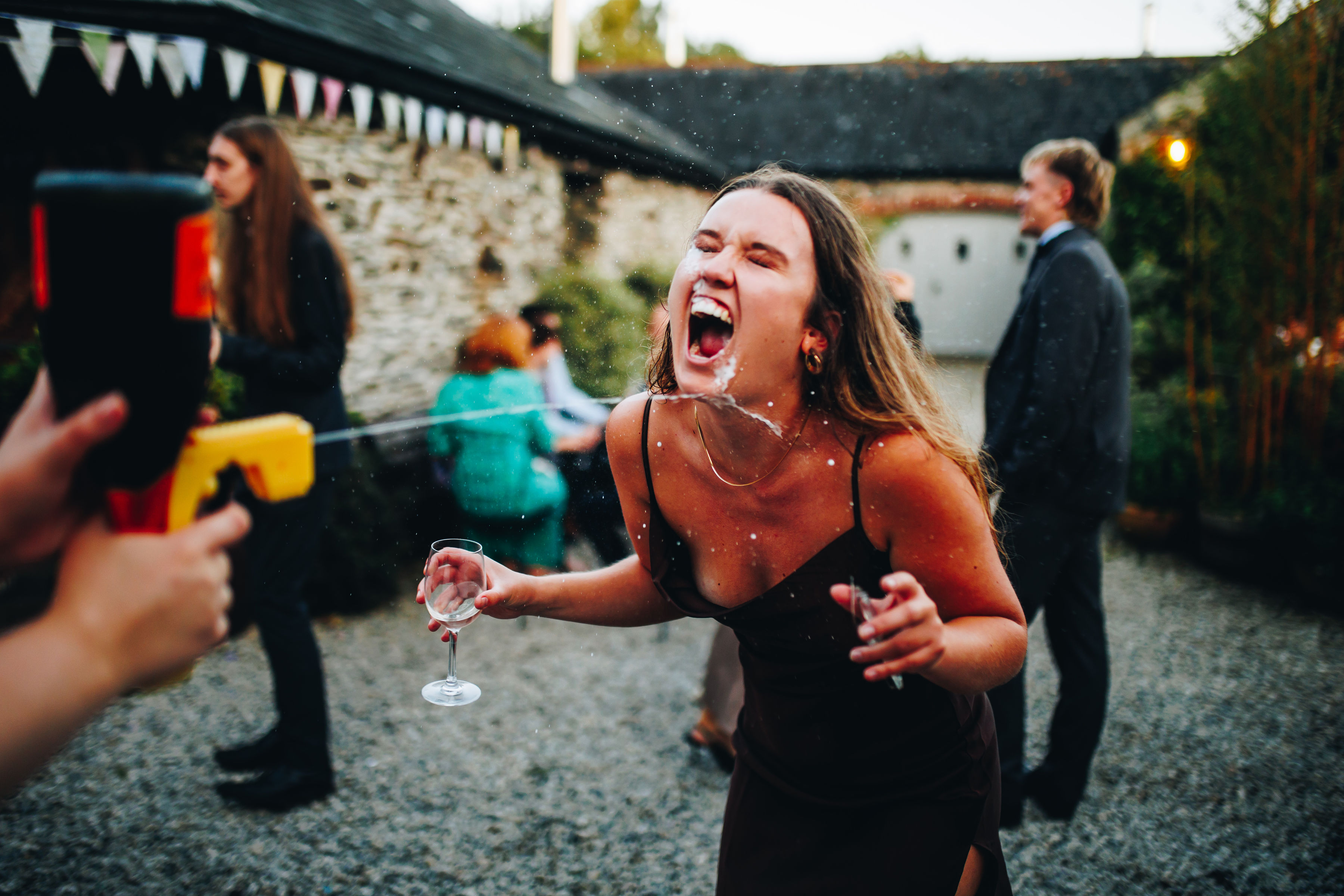 Bridesmaid using Prosecco gun