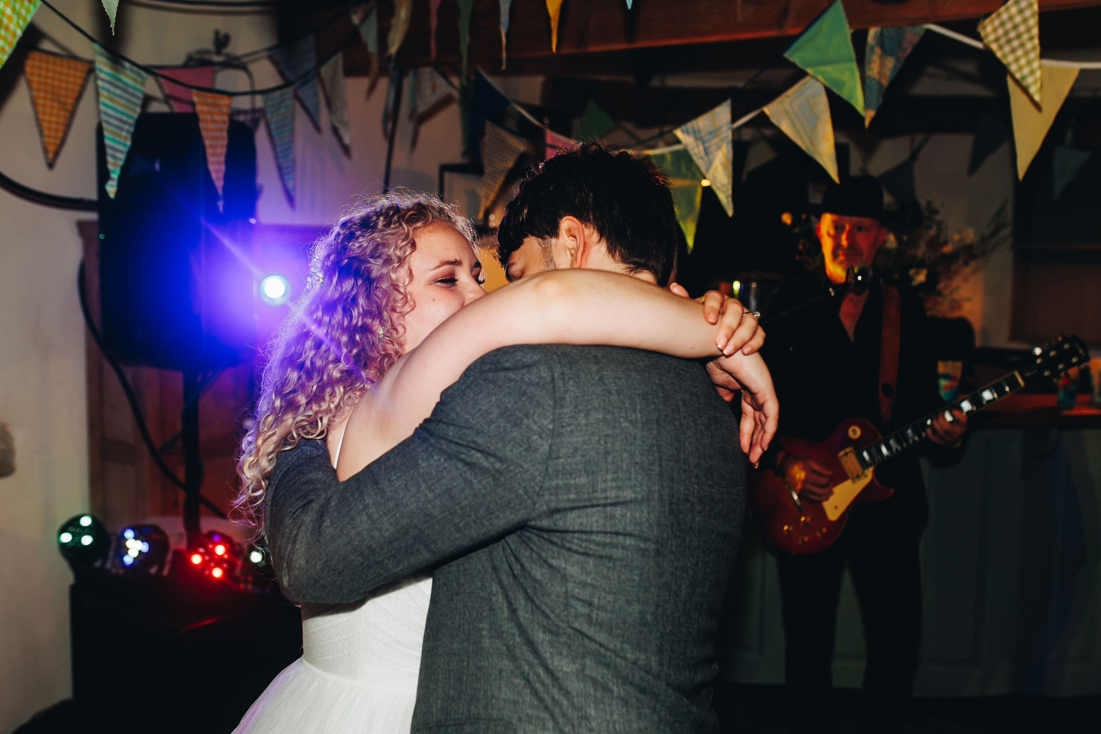 Bride and groom hugging and dancing on the dancefloor