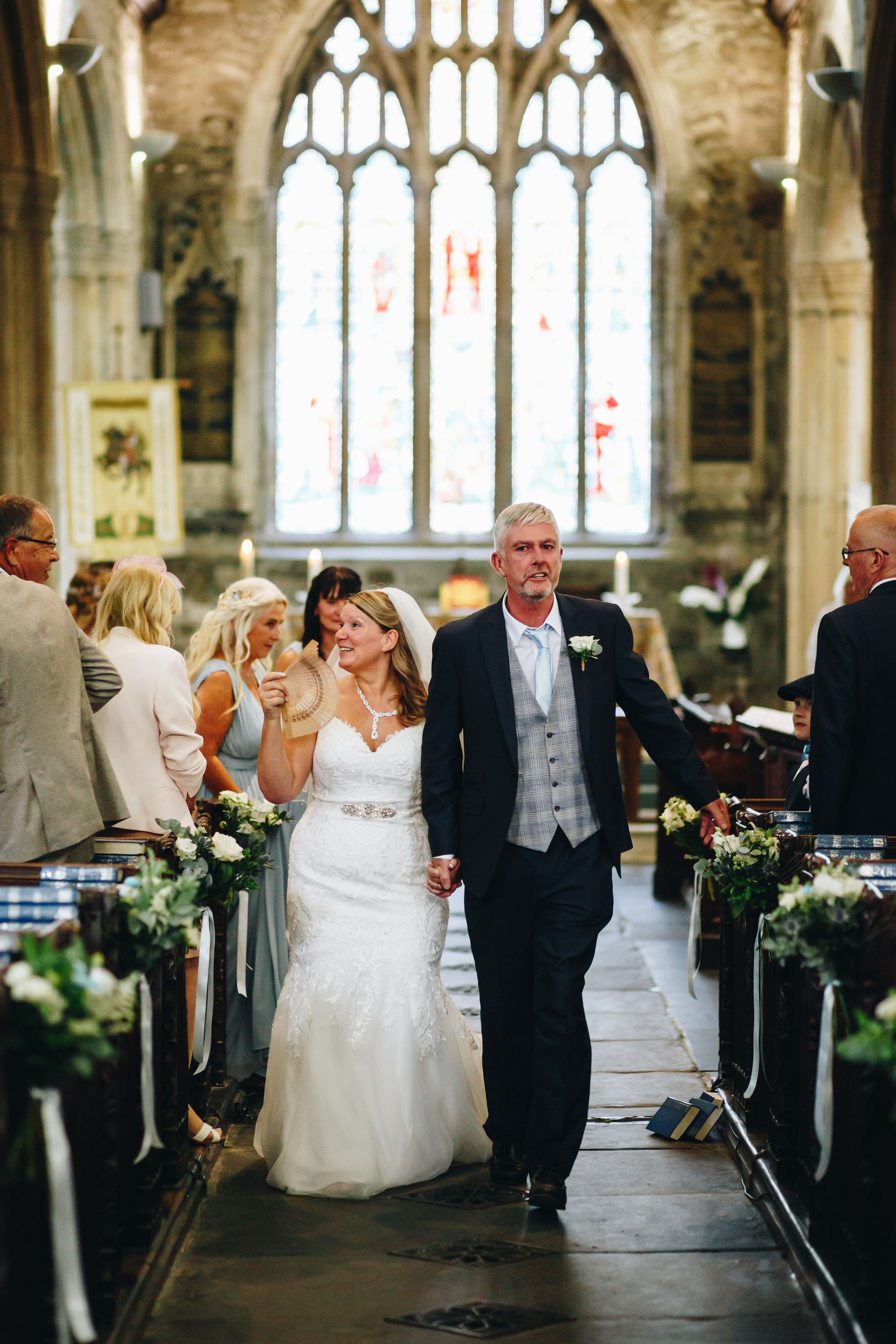 Couple walking up church aisle