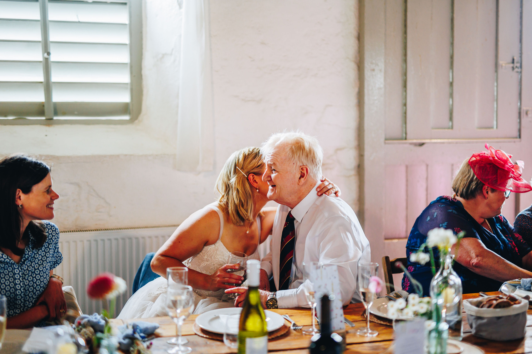Bride and her dad embracing at the wedding reception