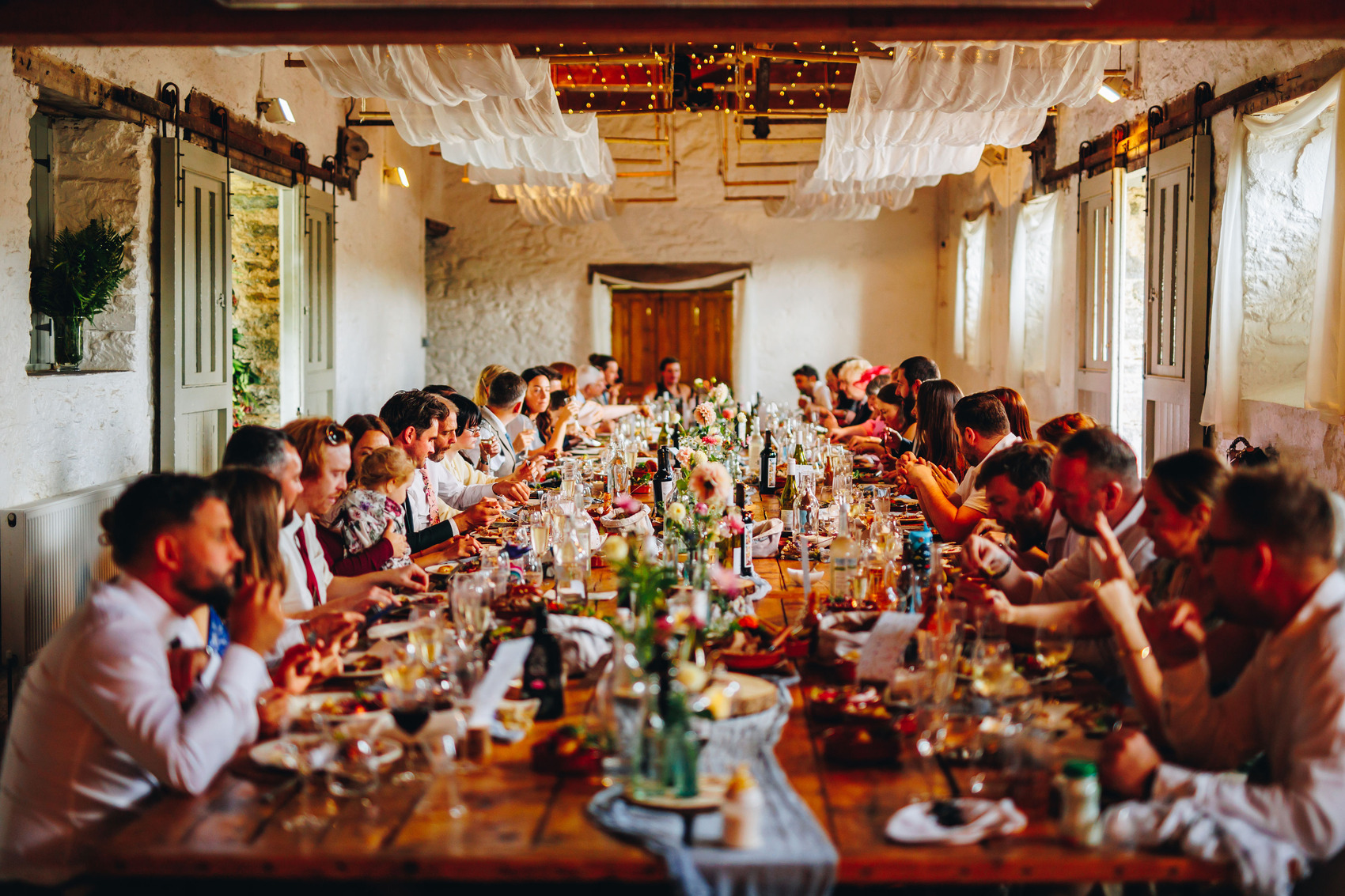 Tablescape at a wedding reception at Bradstone Manor, with florals down the centre of the table