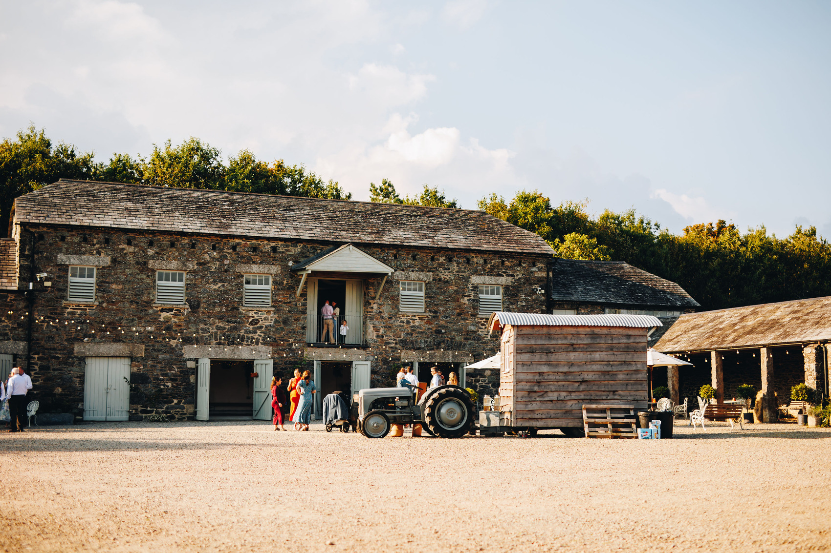 Bradstone Manor from across the courtyard, with guests mingling and having fun