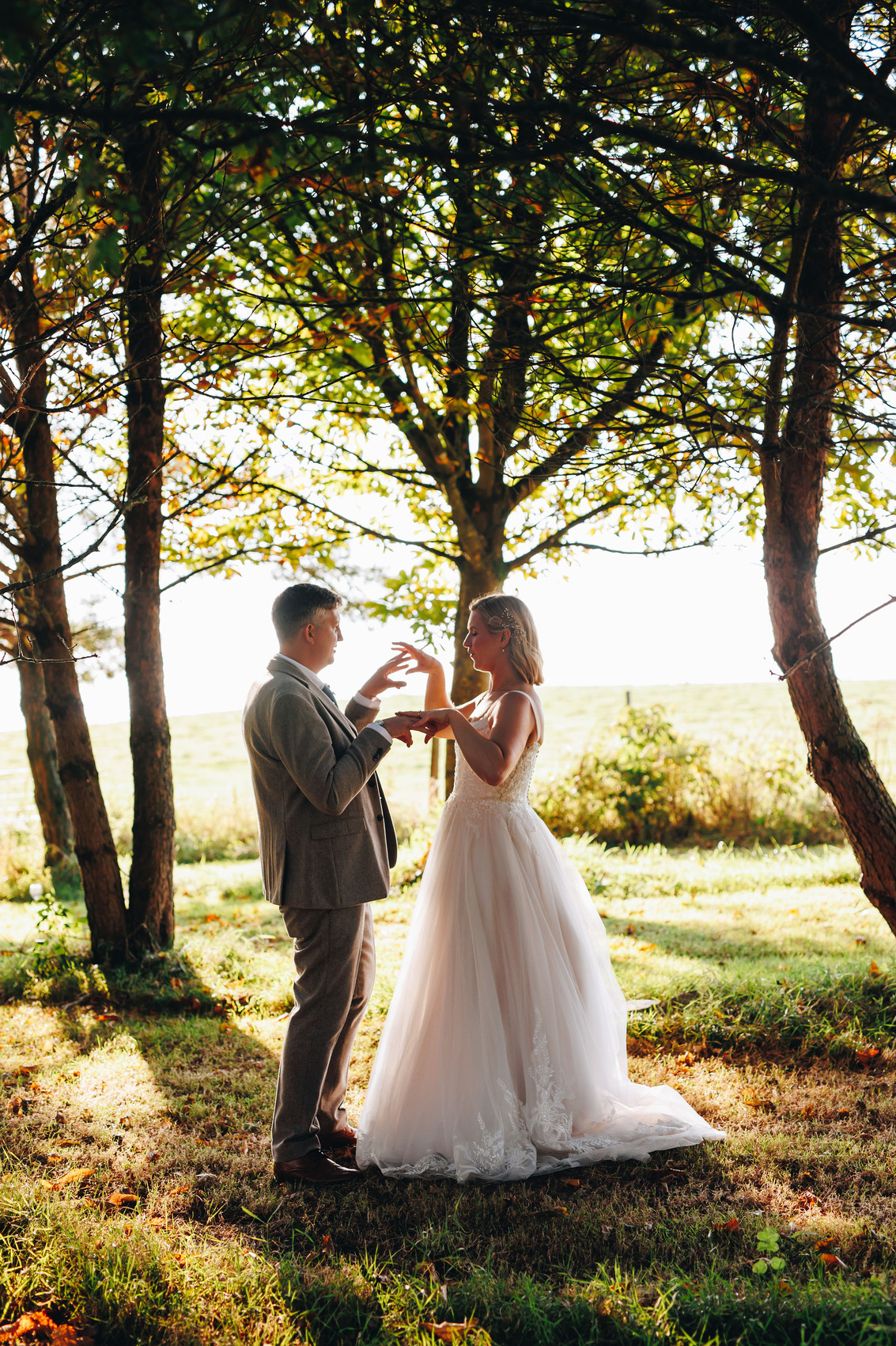 Bride and groom amongst the trees near sunset