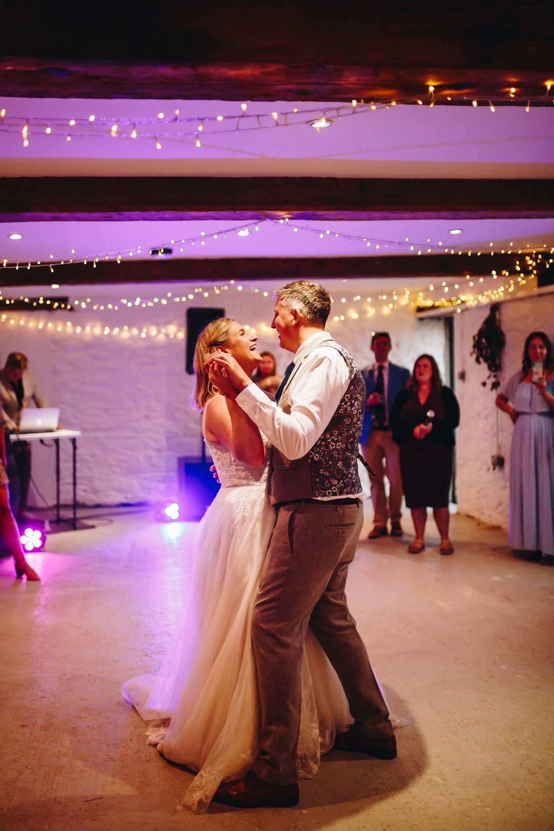 Bride and groom dancing on the dancefloor under the fairylights