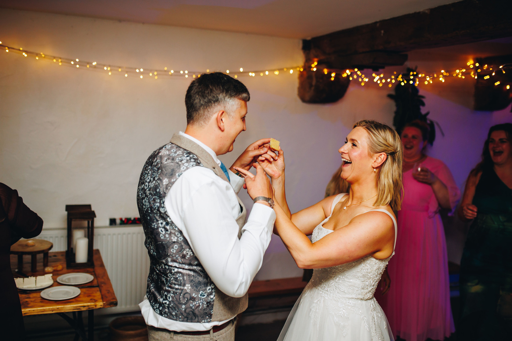 Bride and groom feeding each other wedding cake